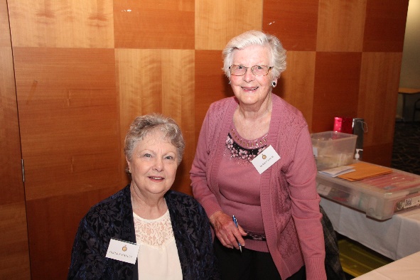 A couple of older women posing for a photo Description automatically generated