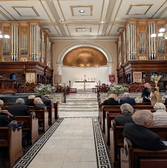 A group of people in a church AI-generated content may be incorrect.