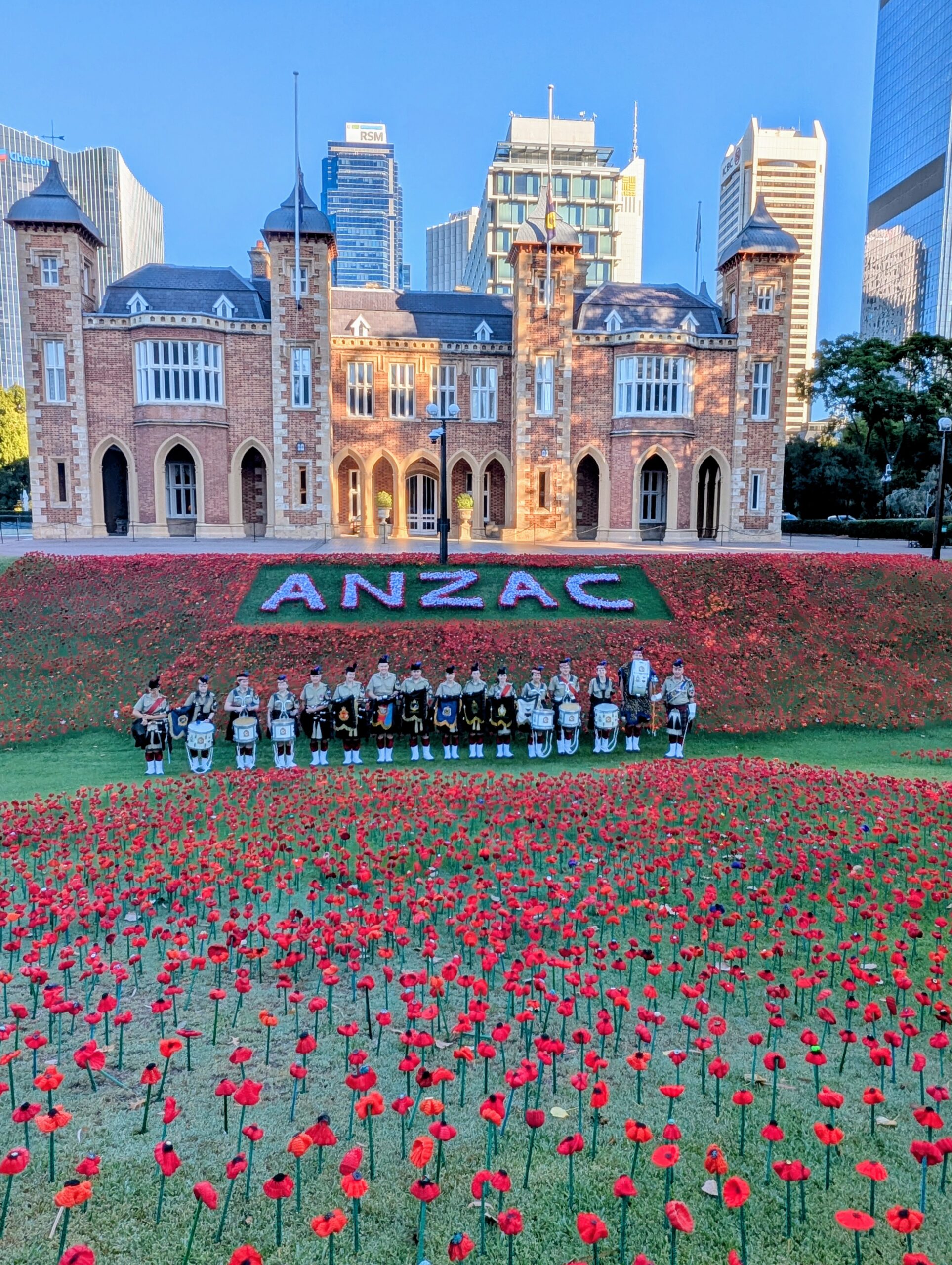 A group of people in uniform in front of a large building AI-generated content may be incorrect.
